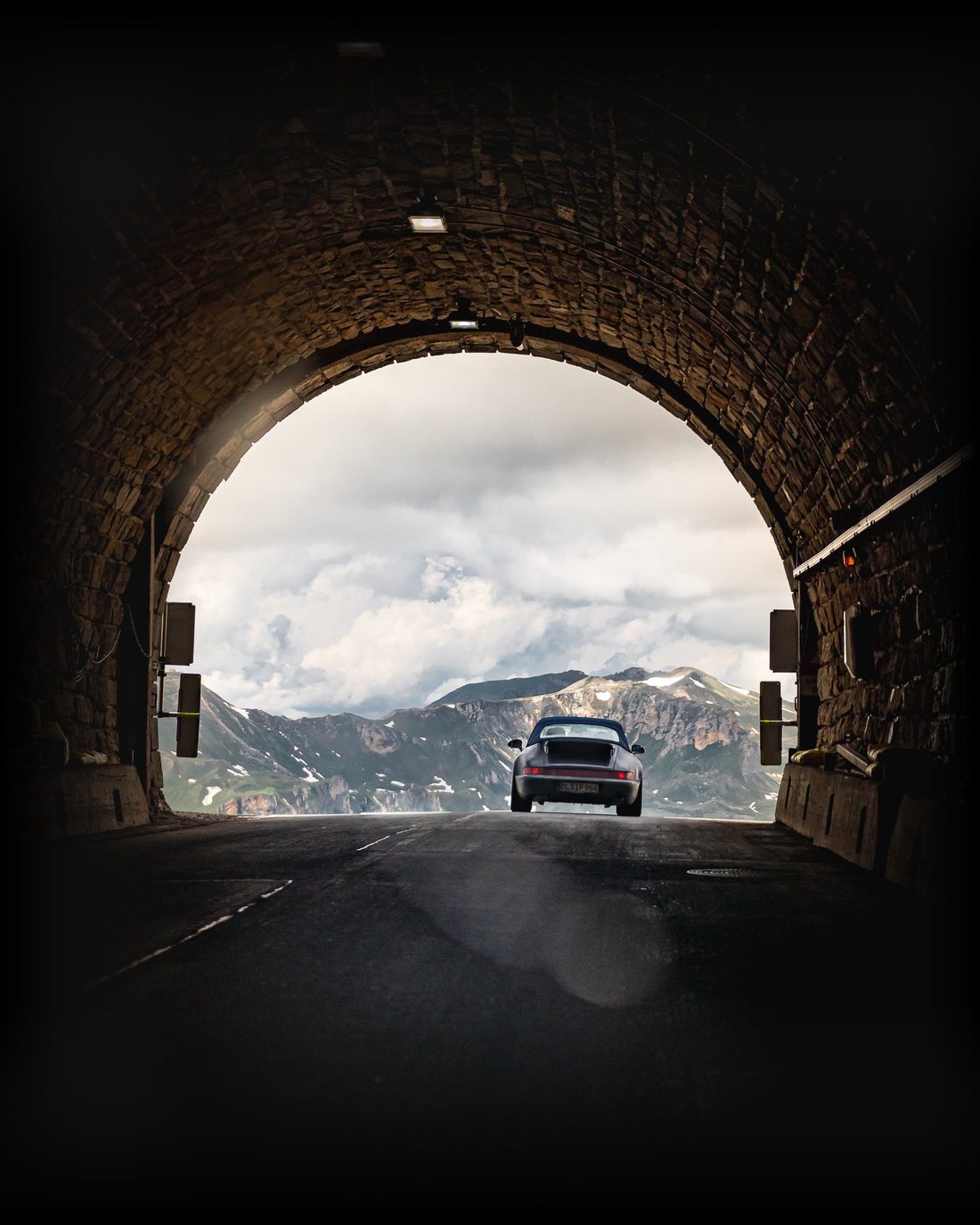 Classic Porsche emerging from an alpine tunnel